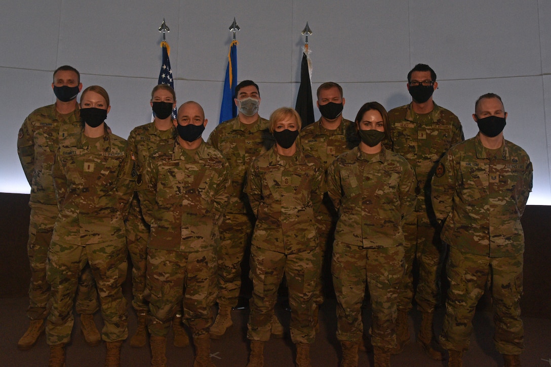 U.S. Air Force Col. Andres Nazario, 17th Training Wing commander and Chief Master Sgt. Casy Boomershine, 17th TRW command chief, stand with the newly transferred Guardians at Angelo State University’s Planetarium in San Angelo, Texas, March 26, 2021. The Space Force’s responsibilities include: developing Guardians, acquiring military space systems, maturing the military doctrine for space power and organizing space forces to present to our Combatant Commands.  (U.S. Air Force photo by Senior Airman Ashley Thrash)