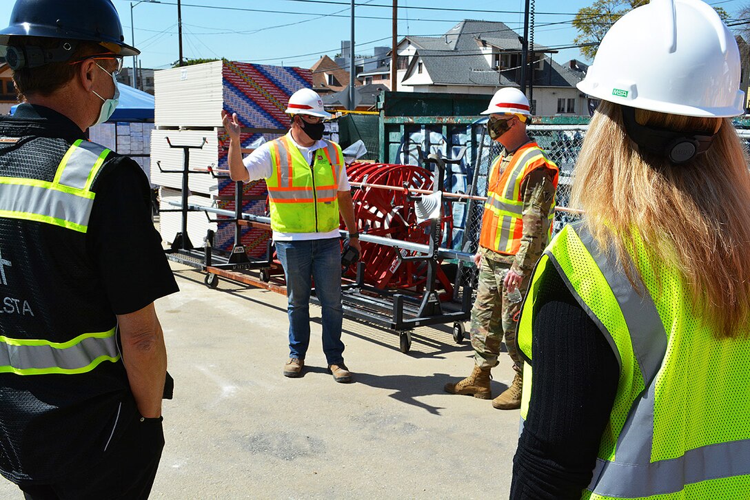 Jeremy Ayala, contracting officer representative for the U.S. Army Corps of Engineers Omaha District, center left, briefs Brig. Gen. Paul Owen, commander of the Corps’ South Pacific Division, center right, March 19 about the Corps and its contractors’ construction progress on an alternate care facility at Adventist Health White Memorial Medical Center in the Boyle Heights neighborhood in Los Angeles, while Ola Ostlund with HALLSTA Inc., left, and Mara Bryant with the hospital, look on.