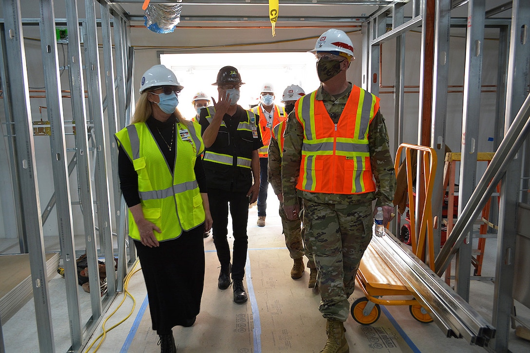 Mara Bryant with Adventist Health White Memorial Medical Center in the Boyle Heights, left, briefs Brig. Gen. Paul Owen, commander of the Corps’ South Pacific Division, right, March 19 about the Corps and its contractors’ construction progress on an alternate care facility at the hospital. Also pictured is Ola Ostlund with HALLSTA Inc., center.