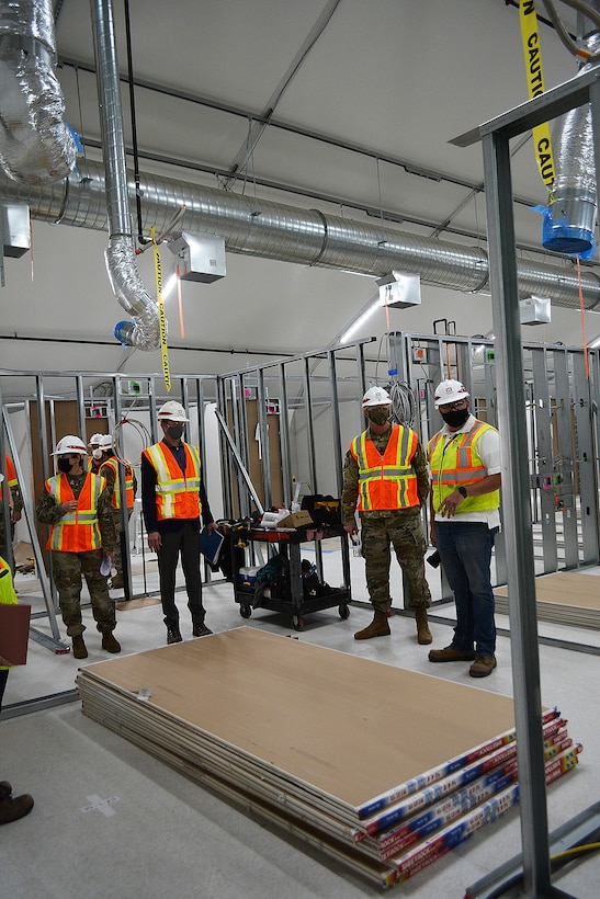 Brig. Gen. Paul Owen, commander of the U.S. Army Corps of Engineers South Pacific Division, second from right, receives a brief about the Corps and its contractors’ construction progress on an alternate care facility at Adventist Health White Memorial Medical Center in the Boyle Heights neighborhood in Los Angeles.