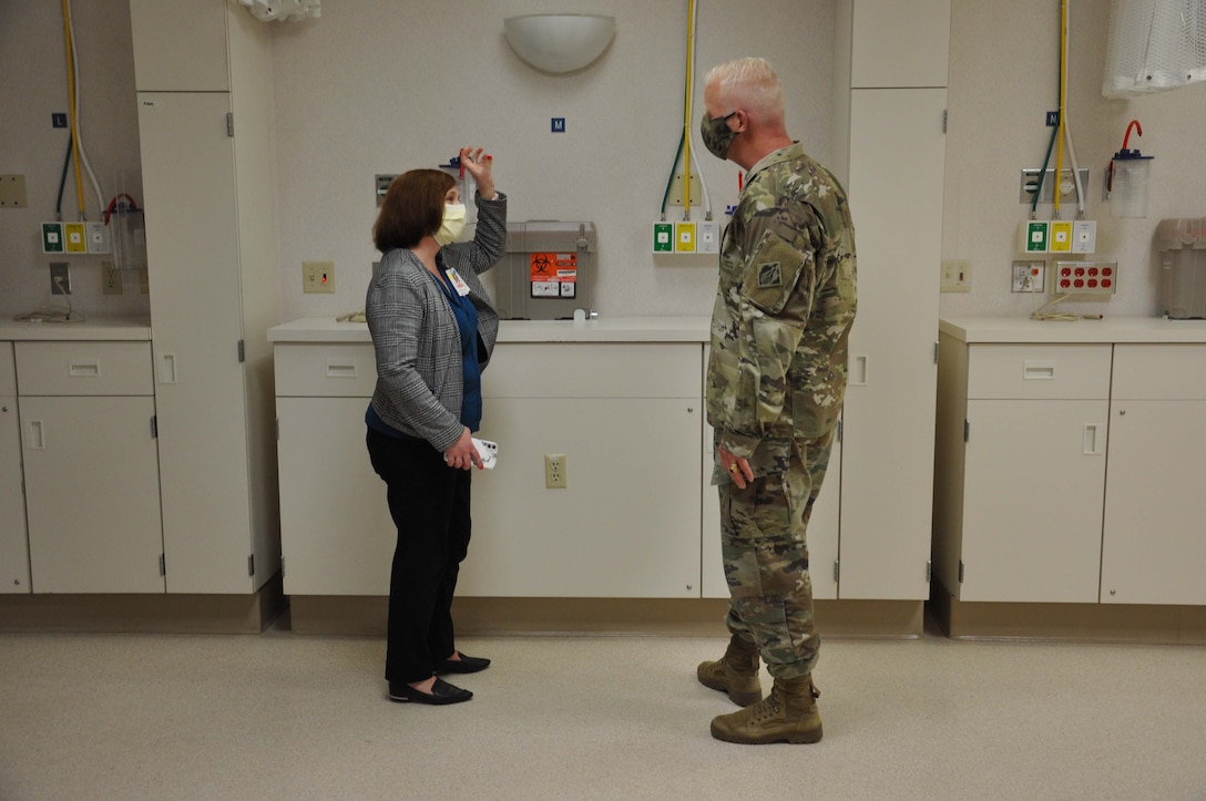 Victoria Bane, director of facilities at Beverly Community Hospital in Montebello, California, left, talks to Brig. Gen. Paul Owen, commander of the U.S. Army Corps of Engineers South Pacific Division, right, during a March 19 tour of the hospital. The Corps and its contractors completed the conversion of the hospital’s west wing into a 17-room, NON-COVID patient area and the hospital’s day care waiting room into a COVID patient staging area, by adding high-flow oxygen and converting the area to negative pressure. The final inspection of the construction work at the hospital was completed earlier that morning.