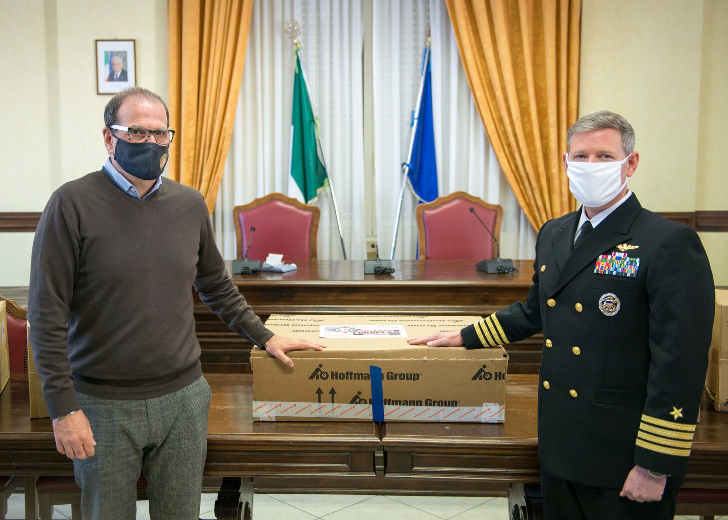 Capt. David Pollard, Commanding officer of the Blue Ridge-class command and control ship USS Mount Whitney, and Cosmo Mitrano, mayor of Gaeta, Italy, pose for a photo during a medical supplies donation to Gaeta, Italy on behalf of the USS Mount Whitney (LCC 20) in Gaeta, March 26, 2021.