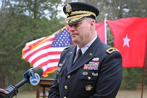 soldier in dress uniform speaking to a reporter