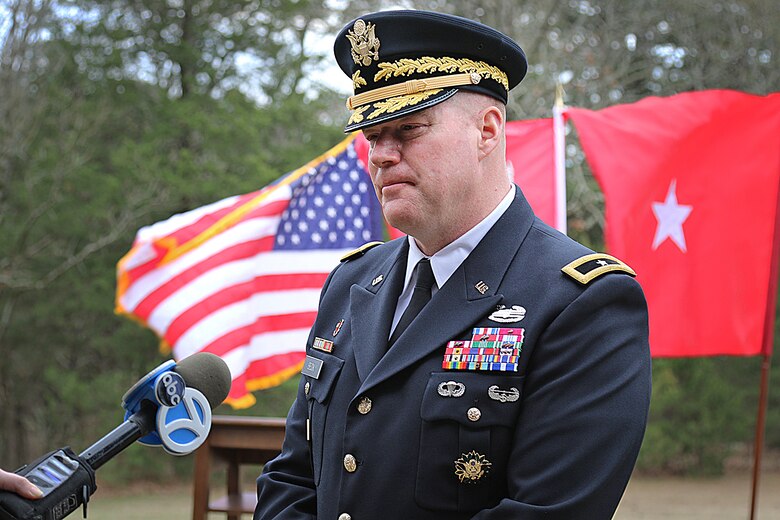 soldier in dress uniform speaking to a reporter