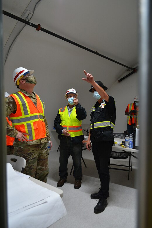 Ola Ostlund with HALLSTA Inc., right, points out a feature inside an alternate care facility built by the Corps and its contractors, to Brig. Gen. Paul Owen, commander of the U.S. Army Corps of Engineers South Pacific Division, left, while Jamil Abuniaj, civil engineer with the Corps’ LA District, looks on during a March 19 tour of the project site at Adventist Health White Memorial Medical Center in the Boyle Heights neighborhood of Los Angeles.