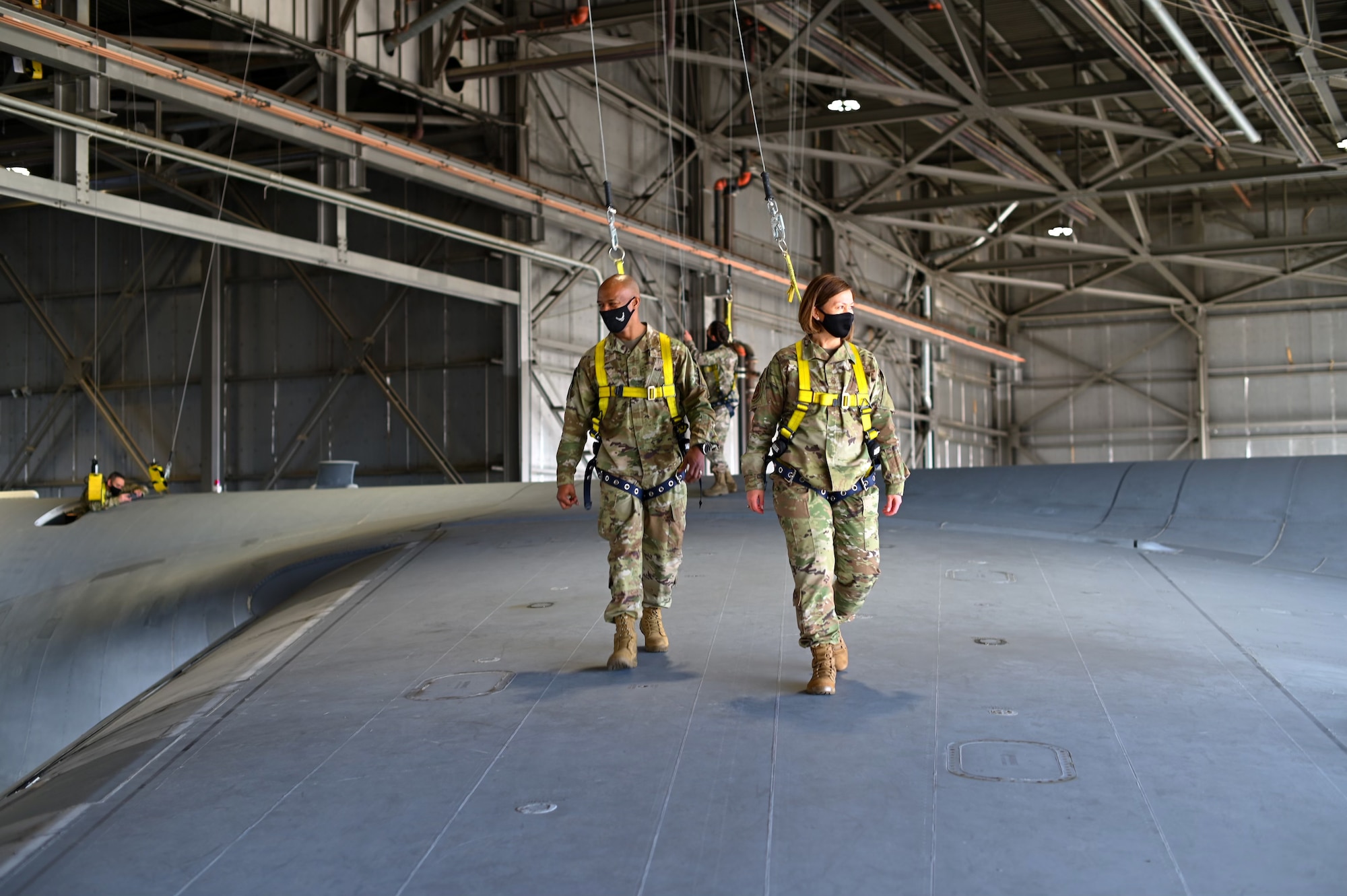 Chief Master Sergeant Mike Perry, Air Force first sergeant special duty manager, and Chief Master Sergeant of the Air Force JoAnne S. Bass, walk on the wing of a C-5M Super Galaxy March 25, 2021, at Travis Air Force Base, Calif. Bass visited Travis AFB to meet the Airmen who demonstrate innovative thinking and enhance the rapid global mobility mission.