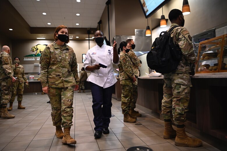 Chief Master Sergeant of the Air Force JoAnne S. Bass the Monarch Dining Facility with Senior Airman Fredmalyn Jackson, 60th Force Support Squadron food service worker, March 24, 2021, at Travis Air Force Base, Calif. Bass visited Travis AFB to meet the Airmen who demonstrate innovative thinking and enhance the rapid global mobility mission.