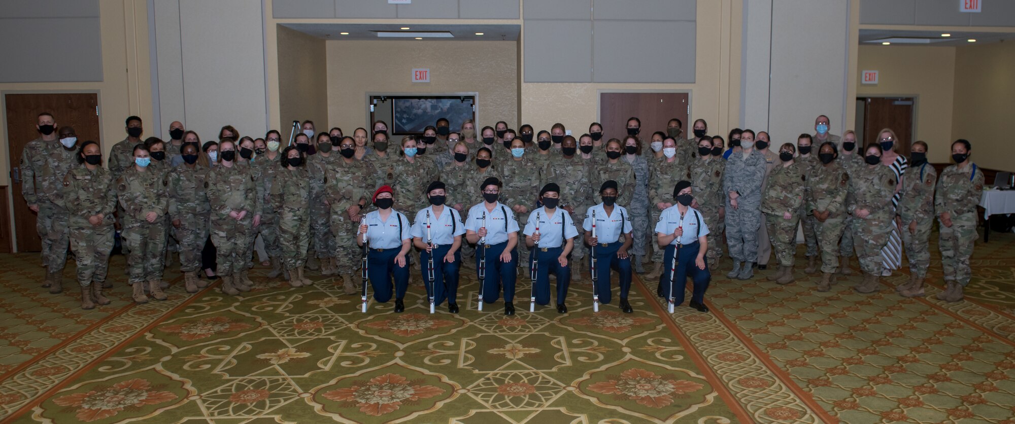 The 2021 Mississippi Veteran Affairs Military Women's Summit attendees pose for a photo in the Bay Breeze Event Center at Keesler Air Force Base, Mississippi, March 25, 2021. The summit focused on the goal of supporting a diverse and inclusive force catered to veterans, retirees, reservists, active duty and national guard members. (U.S. Air Force photo by Andre' Askew)