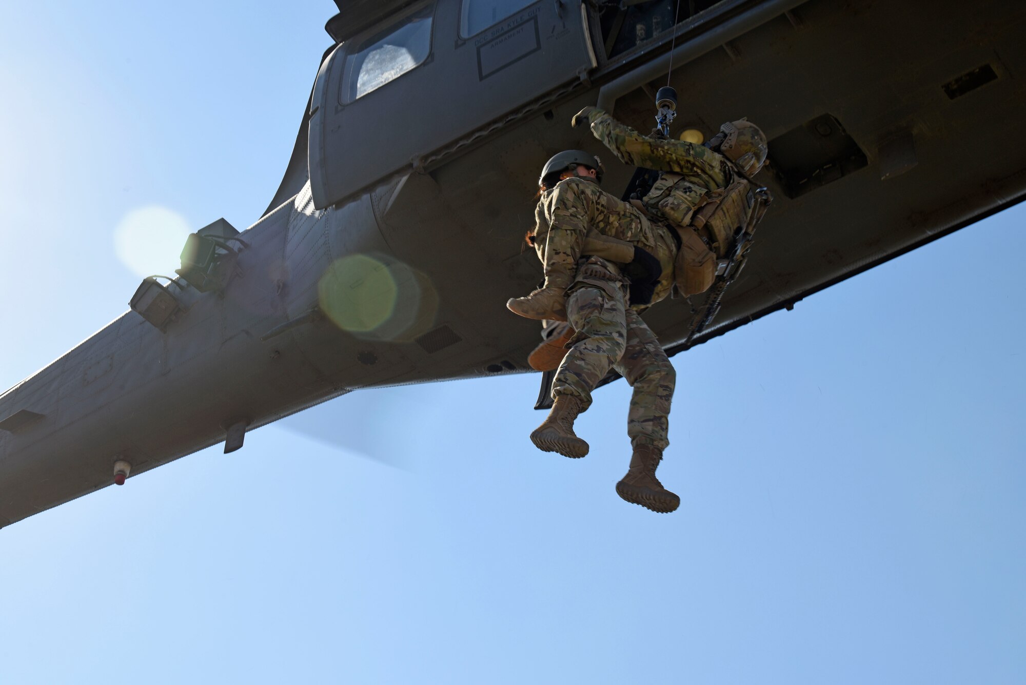 Airmen hoisted up to helicopter