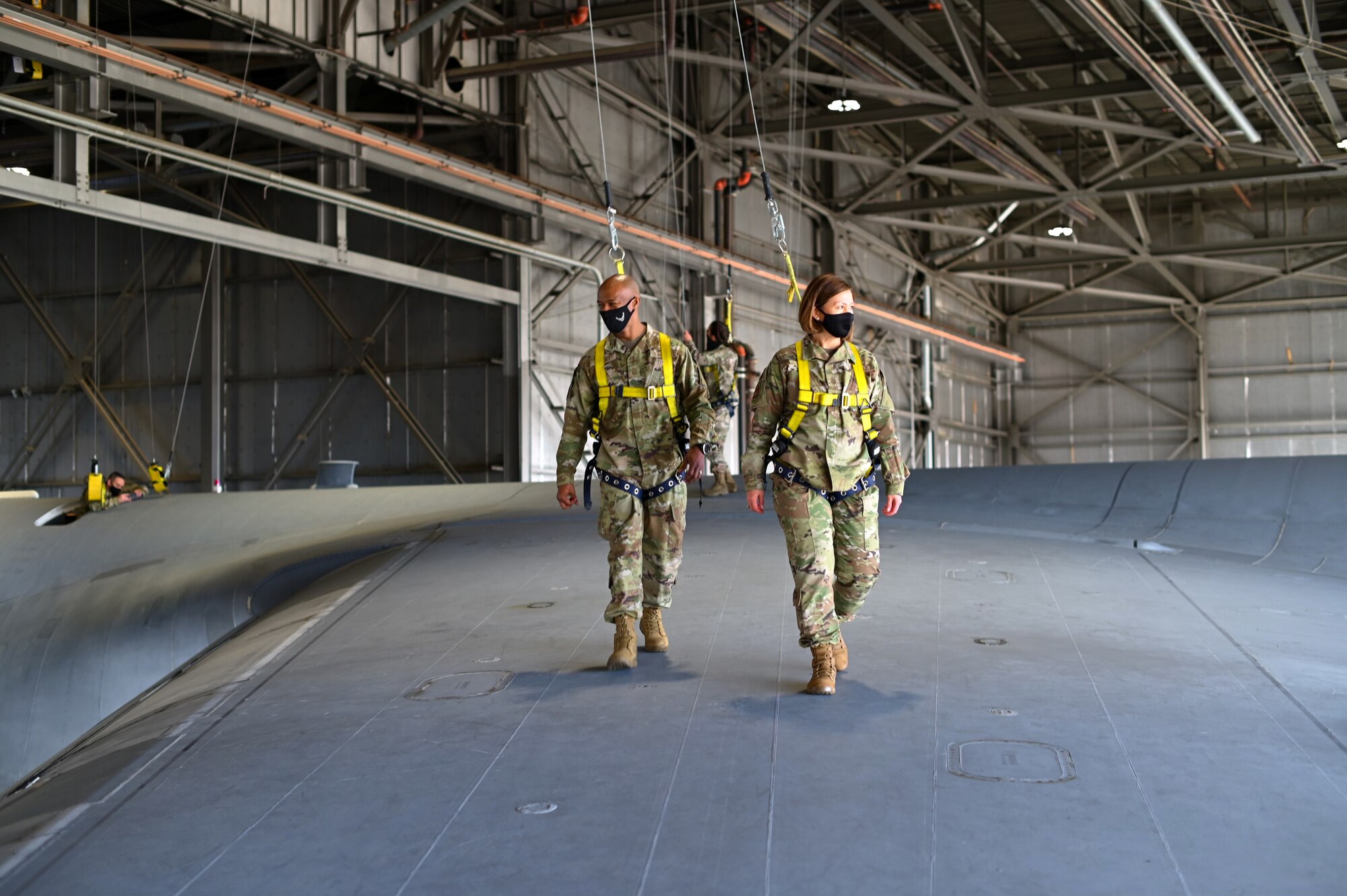 Chief Master Sergeant of the Air Force JoAnne S. Bass, right, and Chief Master Sergeant Mike Perry Air Force, first sergeant special duty manager, walk on the wing of a C-5M Super Galaxy March 25, 2021, at Travis Air Force Base, California. Chief Bass visited Travis AFB to meet the Airmen who demonstrate innovative thinking and enhance the rapid global mobility mission. (U.S. Air Force photo by Senior Airman Karla Parra)