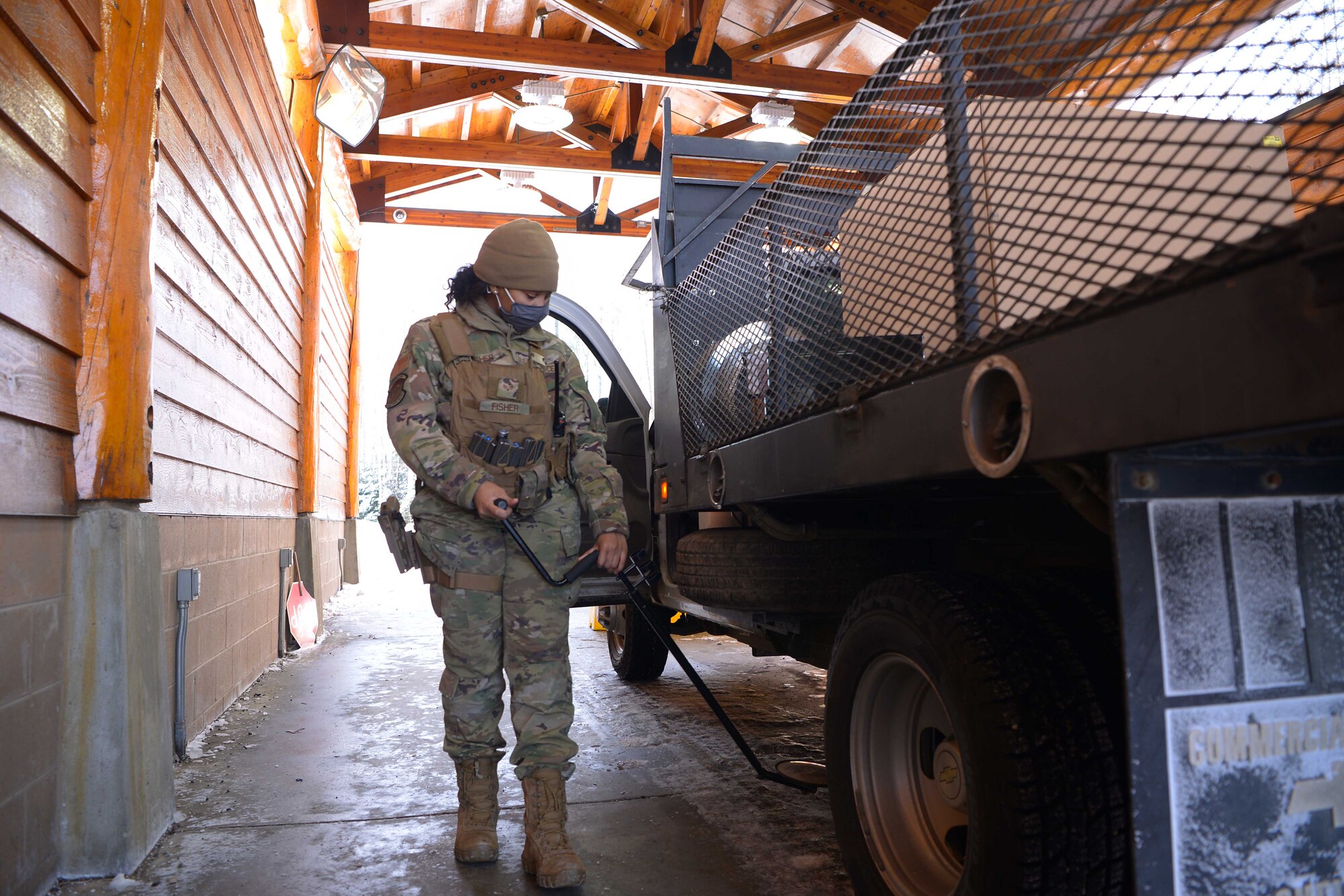 U.S. Air Force Senior Airman Heaven Fisher, a 354th Security Forces Squadron response force leader, searches a vehicle for explosives and contraband March 16, 2021, on Eielson Air Force Base Alaska. Security Forces defenders are responsible for protecting Air Force families and property 24/7 by providing law enforcement and security services. (U.S. Air Force photo by Senior Airman Beaux Hebert)