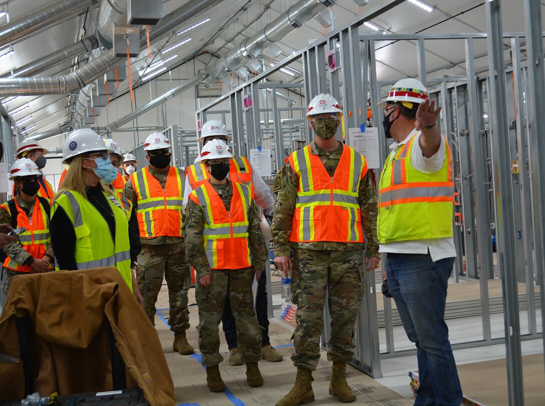 Jeremy Ayala, contracting officer representative for the U.S. Army Corps of Engineers Omaha District, center right, briefs Brig. Gen. Paul Owen, commander of the Corps’ South Pacific Division, second from right, and Col. Julie Balten, commander of the Corps’ Los Angeles District, center, March 19 about the Corps and its contractors’ construction progress on an alternate care facility at Adventist Health White Memorial Medical Center in the Boyle Heights neighborhood in Los Angeles.