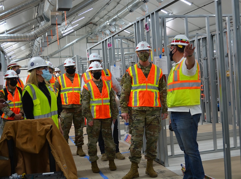 Jeremy Ayala, contracting officer representative for the U.S. Army Corps of Engineers Omaha District, center right, briefs Brig. Gen. Paul Owen, commander of the Corps’ South Pacific Division, second from right, and Col. Julie Balten, commander of the Corps’ Los Angeles District, center, March 19 about the Corps and its contractors’ construction progress on an alternate care facility at Adventist Health White Memorial Medical Center in the Boyle Heights neighborhood in Los Angeles.
