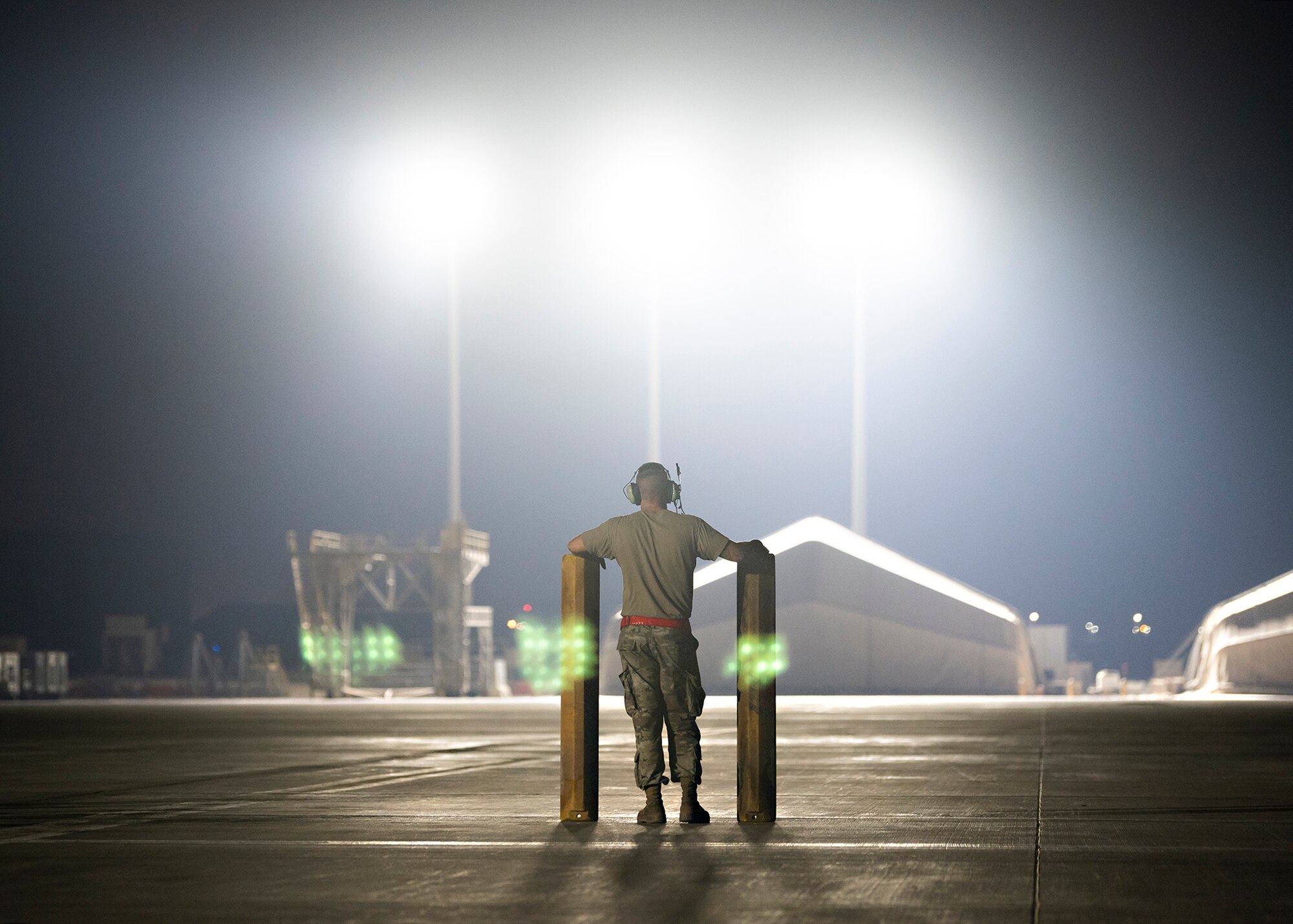 A U.S. Airman holds up aircraft chocks.