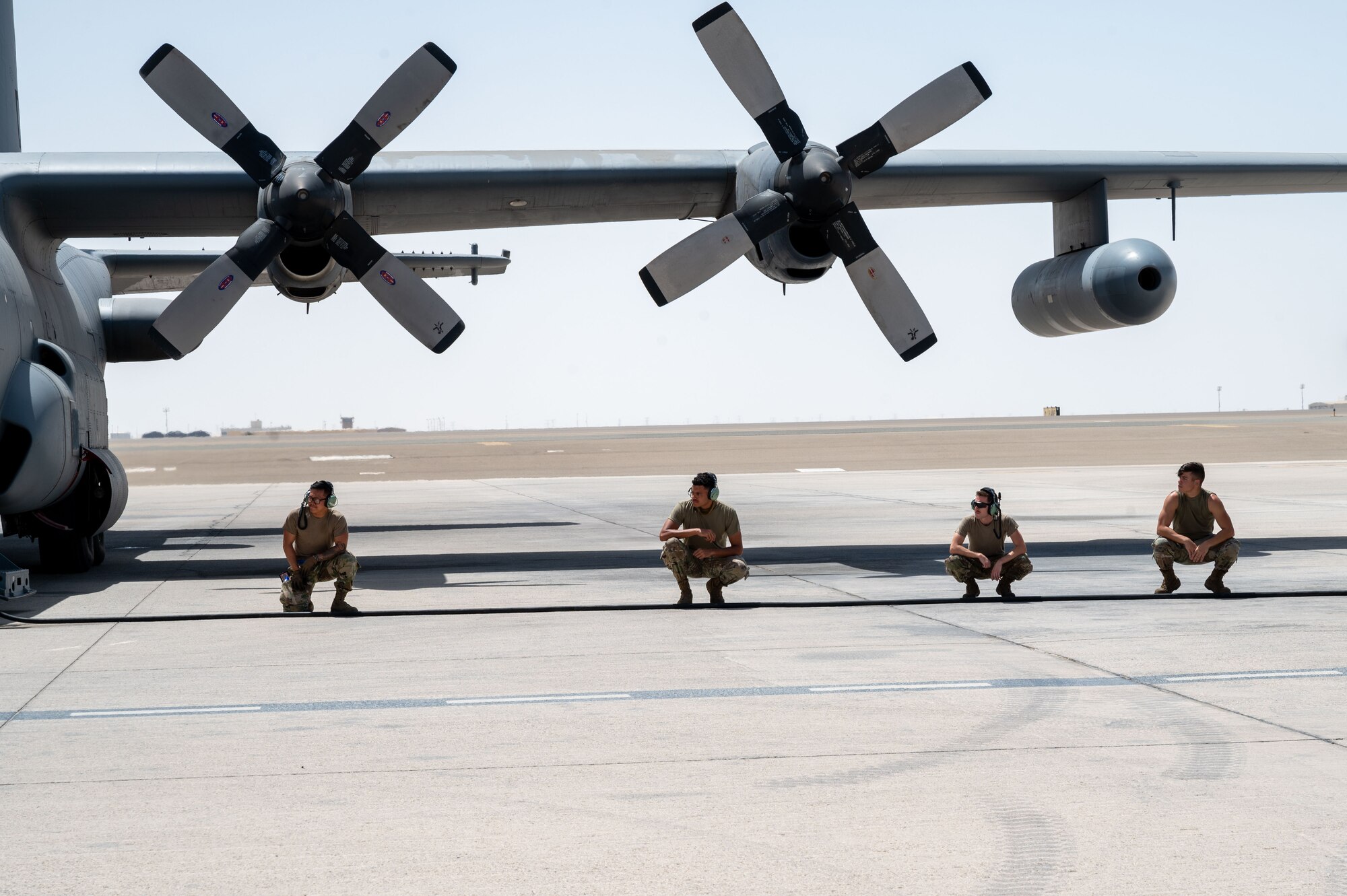 Airmen assigned to the 380th Expeditionary Aircraft Maintenance Squadron perform final checks before an EC-130H Compass Call