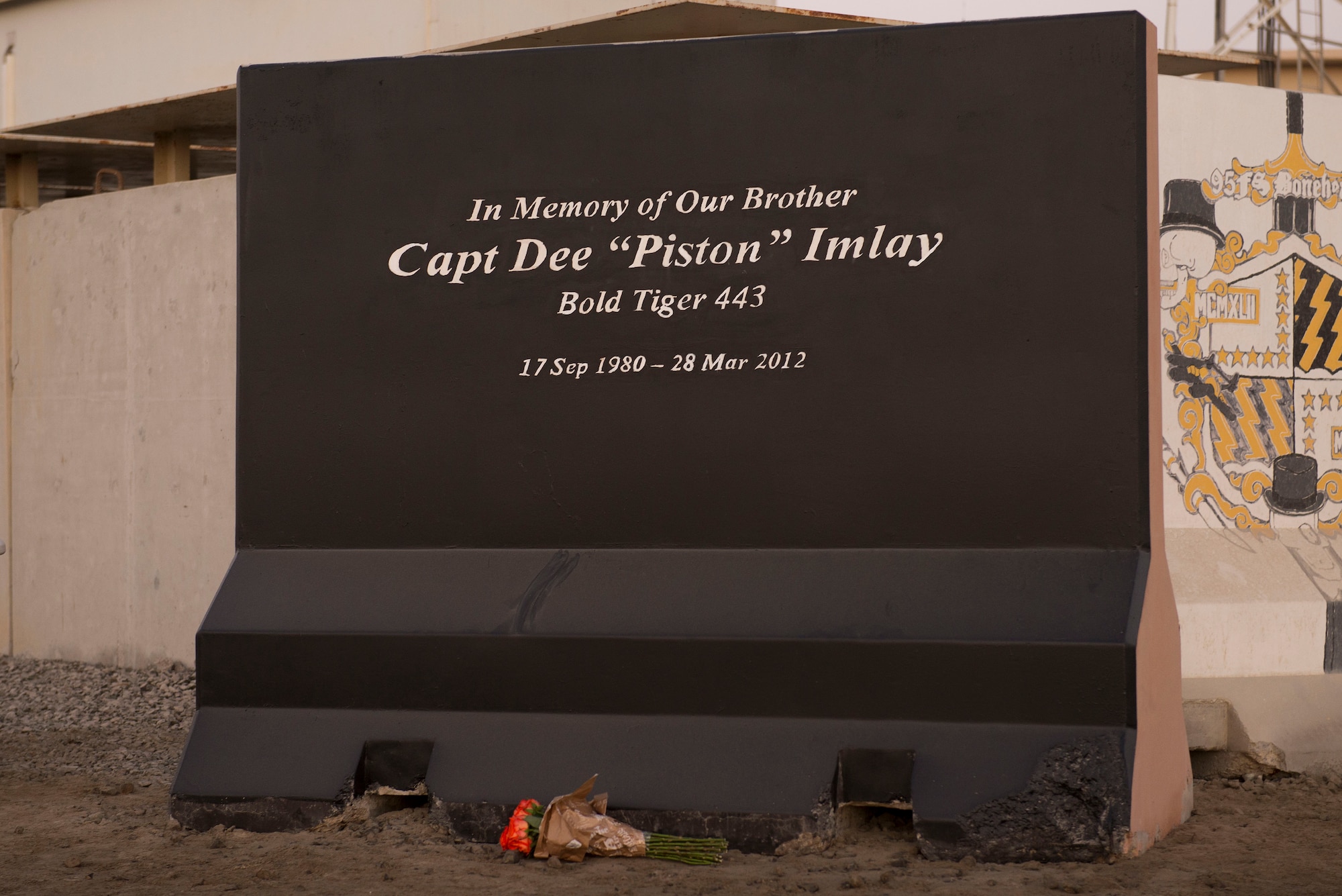 Flowers lay at a memorial honoring U.S. Air Force Capt. Dee “Piston” Imlay, 391st Fighter Squadron F-15 pilot, at Al Dhafra Air Base, United Arab Emirates, March 28, 2021.