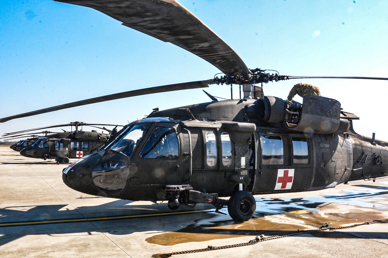 Medical helicopters park on a tarmac.