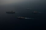 INDIAN OCEAN (March 28, 2021) – The aircraft carrier USS Theodore Roosevelt (CVN 71), left, the Ticonderoga-class guided-missile cruiser USS Bunker Hill (CG 52), center near, the Indian Navy Shivalik-class guided-missile frigate INS Shivalik (F47), center far, and the Arleigh Burke-class guided-missile destroyer USS Russell (DDG 59), sail in formation March 28, 2021. The Theodore Roosevelt Carrier Strike Group is on a scheduled deployment to the U.S. 7th Fleet area of operations. As the U.S. Navy’s largest forward-deployed fleet, 7th Fleet routinely operates and interacts with 35 maritime nations while conducting missions to preserve and protect a free and open Indo-Pacific Region. (U.S. Navy photo by Mass Communication Specialist 3rd Class Brandon Richardson)