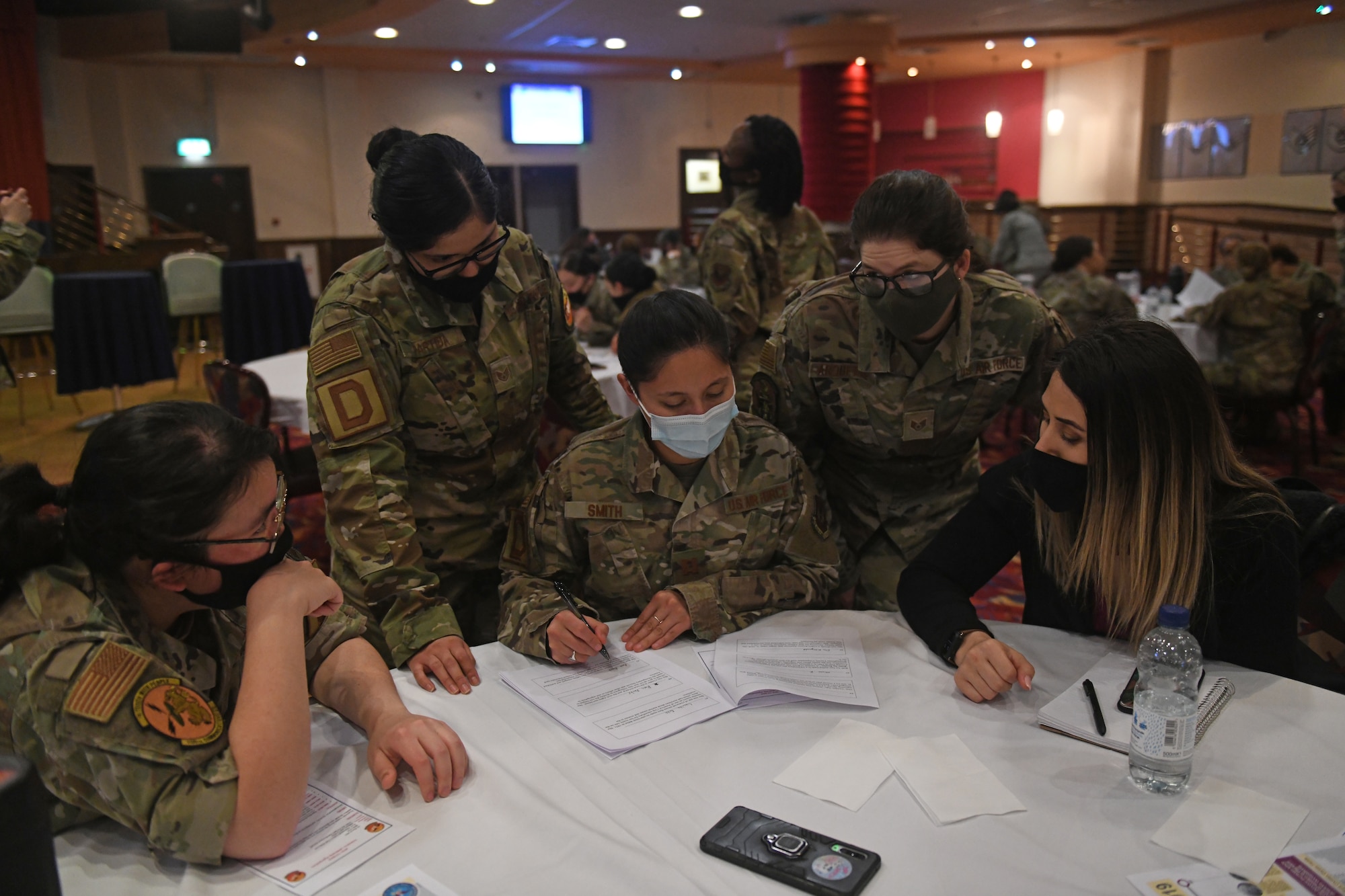 Tri-Base Women’s Leadership Symposium attendees complete a historical trivia questionnaire during a team-building activity at Royal Air Force Mildenhall, England, March 24, 2021. The event aimed to provide women across the tri-base area the opportunity to network and empower one another through open discussion and leadership development. (U.S. Air Force photo by Staff Sgt. Mackenzie Mendez)
