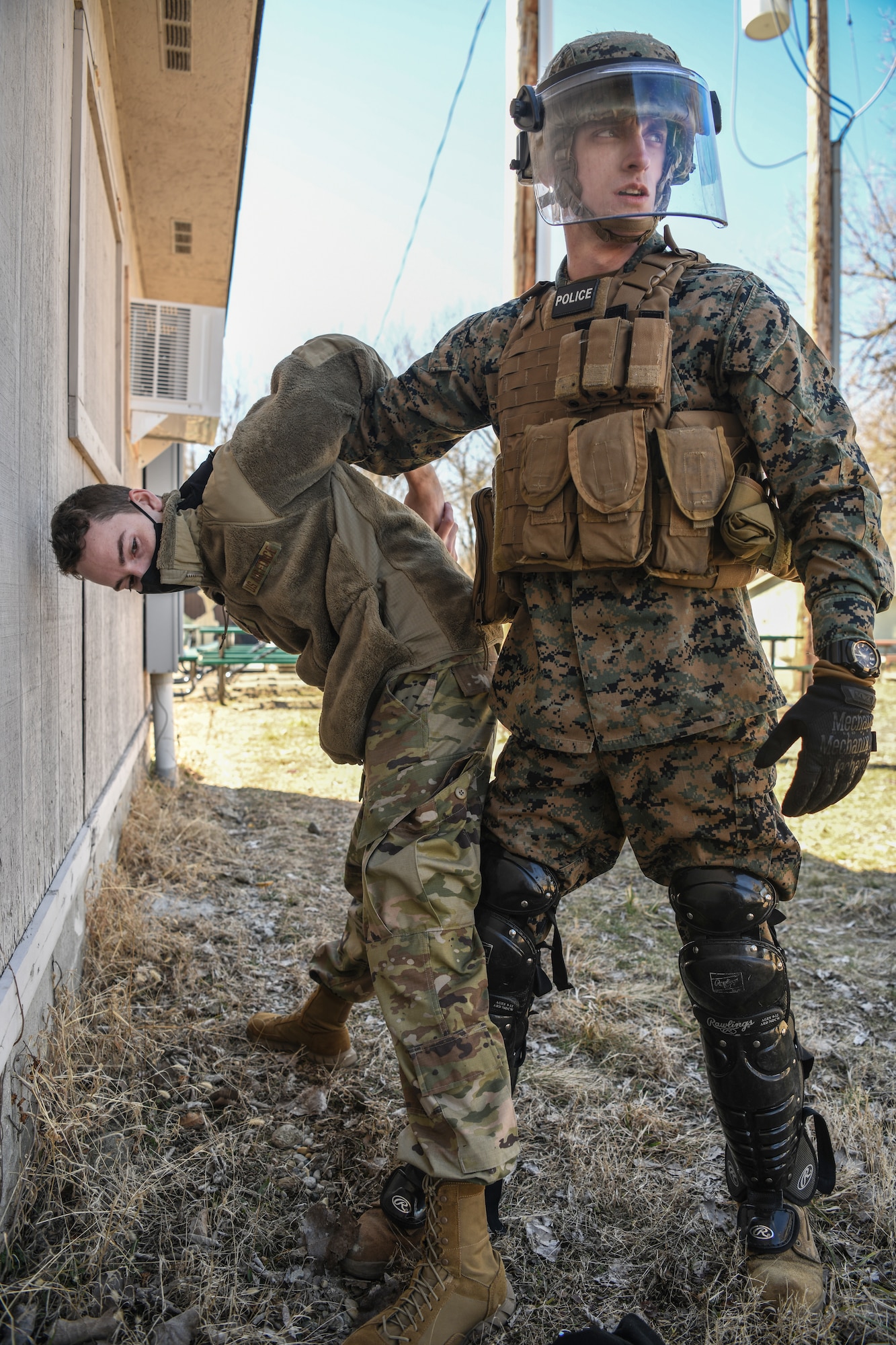 Lance Corporal Colton Sabrowski, Charlie Company, 4th Law Enforcement Battalion Wright-Patterson Air Force Base, Ohio, searches Senior Airman Scott Araujo, 445th Security Forces Squadron, WPAFB, for any dangerous or unlawful items during a training exercise at the Warfighter Training Center here March 6th, 2021. Both Marines and Airmen participated in the detainee operations training adding elements of experience from each branch of service providing total force integration. This experience provides an opportunity for each branch involved to learn and benefit from each other’s techniques. (U.S. Air Force photo by Master Sgt. Patrick OReilly)