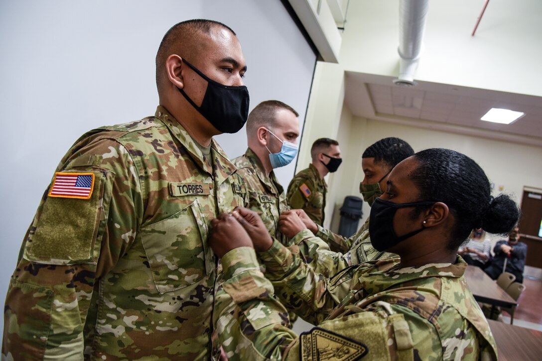 First Sgt. Ebony Bridges promotes one of her Soldiers during ceremony held March 24, 2021, in Richmond, Virginia. Bridges is assigned to Bravo Company of the Virginia National Guard's Recruiting and Retention Battalion. (U.S. Army National Guard photo by Sgt. 1st Class Terra C. Gatti)