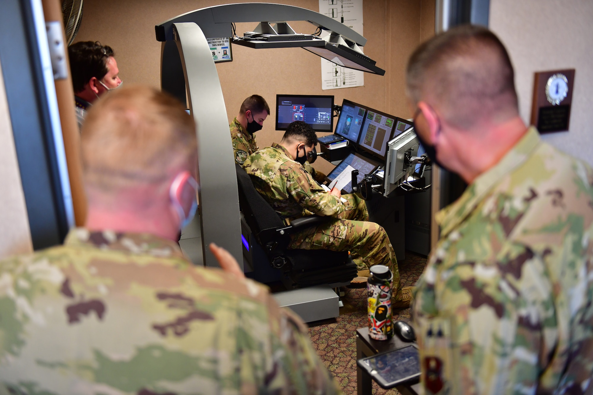 Airman receives overview of fuselage trainer.