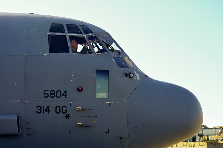 A pilot conducts pre-flight checks on a C-130J Super Hercules.