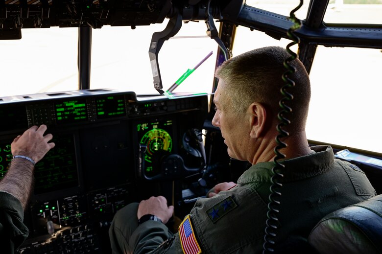 Airmen conduct pre-flight checks on a C-130J Super Hercules.