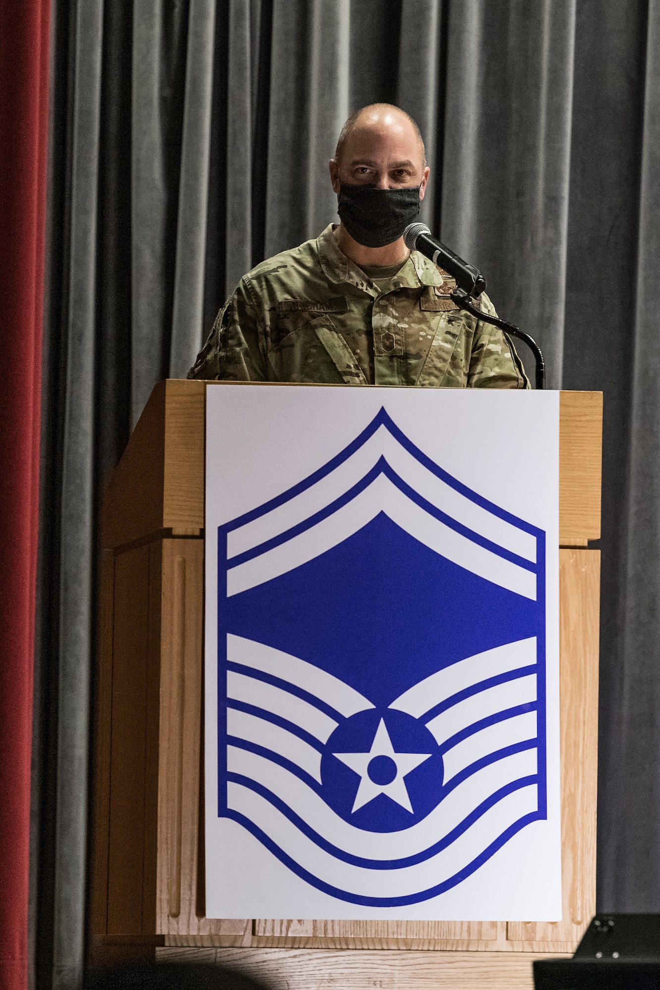 Chief Master Sgt. Jeremiah Grisham, 436th Airlift Wing interim command chief, makes opening remarks during the senior master sergeant promotion release ceremony held at the base theater on Dover Air Force Base, Delaware, March 26, 2021. Ten master sergeants at Dover AFB were selected for promotion to senior master sergeant in the 21E8 promotion cycle. (U.S. Air Force photo by Roland Balik)