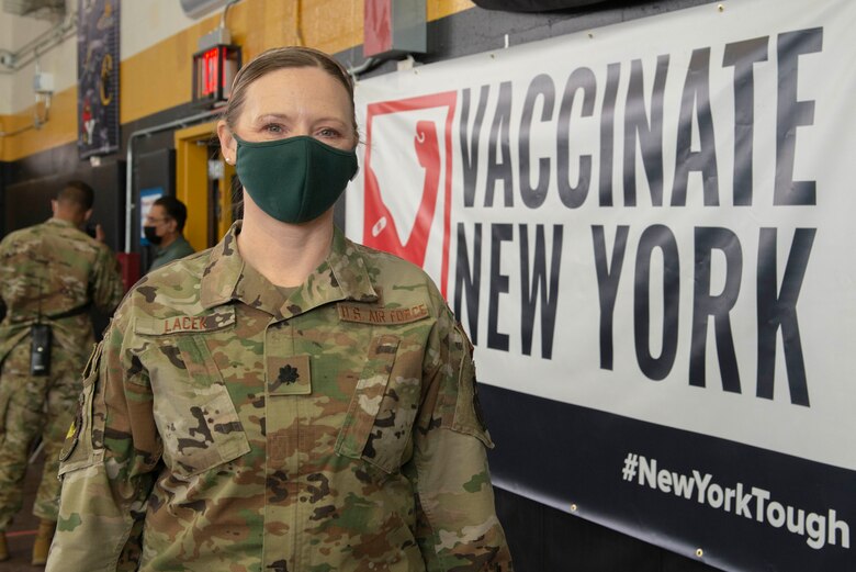 Lt. Col. Angela Lacek, a Port Huron, Mich., native and the 335th Expeditionary Medical Operations Squadron chief nurse, takes a quick break from her duties providing vaccinations at the state-led, federally supported Medgar Evers College Community Vaccination Center in Brooklyn, N.Y., March 22, 2021. Lacek is deployed from the 42nd Medical Group out of Maxwell Air Force Base, Ala., and is one of approximately 140 Airmen across 28 installations deployed to the Medgar Evers College CVC in support of U.S. Army North's COVID-19 response efforts. (U.S. Air Force photo by Tech. Sgt. Ashley Nicole Taylor)