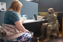 Maj. Toni McGee, a Columbia, S.C., native and 335th Expeditionary Medical Operations Squadron team lead, verifies medical information with a community member at the state-led, federally supported Medgar Evers College Community Vaccination Center in Brooklyn, N.Y., March 22, 2021. McGee is deployed from the 56th Operational Medical Readiness Squadron out of Luke Air Force Base, Ariz., and is one of approximately 140 Airmen across 28 installations deployed to the Brooklyn CVC in support of the U.S. Army North’s COVID-19 response efforts. (U.S. Air Force photo by Tech. Sgt. Ashley Nicole Taylor)