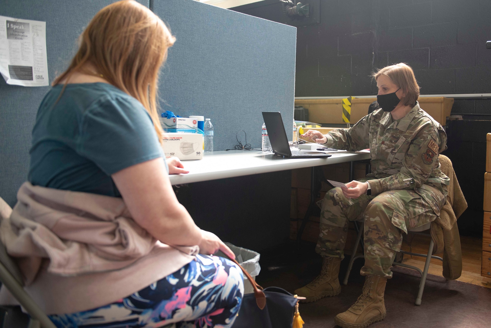 Maj. Toni McGee, a Columbia, S.C., native and 335th Expeditionary Medical Operations Squadron team lead, verifies medical information with a community member at the state-led, federally supported Medgar Evers College Community Vaccination Center in Brooklyn, N.Y., March 22, 2021. McGee is deployed from the 56th Operational Medical Readiness Squadron out of Luke Air Force Base, Ariz., and is one of approximately 140 Airmen across 28 installations deployed to the Brooklyn CVC in support of the U.S. Army North’s COVID-19 response efforts. (U.S. Air Force photo by Tech. Sgt. Ashley Nicole Taylor)