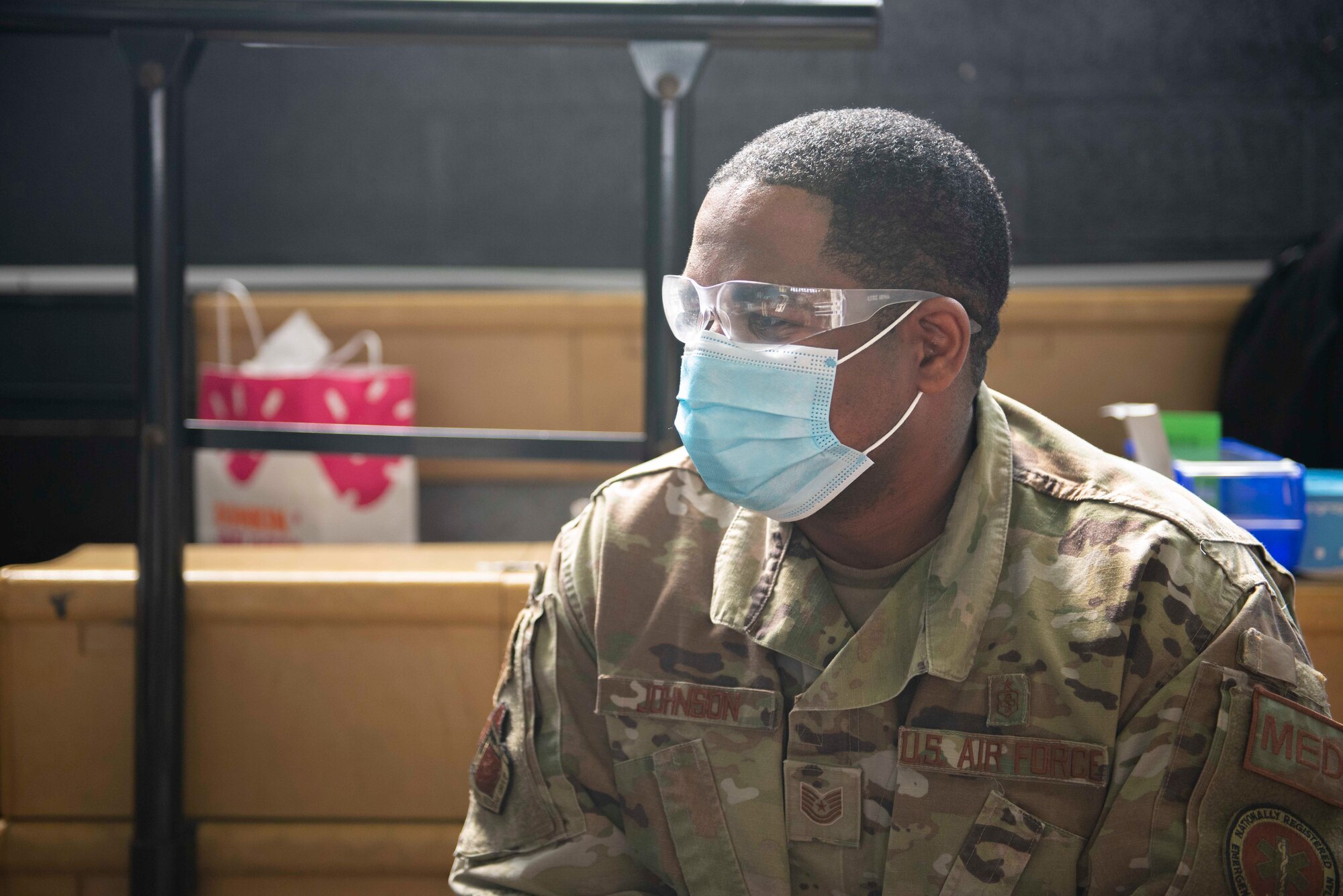 Tech. Sgt. Edric Johnson, an El Paso, Texas, native and 335th Expeditionary Medical Operations Squadron vaccinator, prepares to vaccinate a community member at a Community Vaccination Center in Brooklyn, N.Y., March 22, 2021. Johnson is deployed from the 56th Medical Group out of Luke Air Force Base, Ariz., and is one of approximately 140 Airmen across 28 installations deployed to the Brooklyn CVC in support of U.S. Army North’s COVID-19 response efforts. (U.S. Air Force photo by Tech. Sgt. Ashley Nicole Taylor)