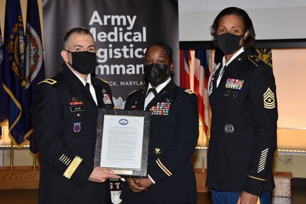 Brig. Gen. Michael Lalor, left, commander of U.S. Army Medical Logistics Command, and AMLC Sgt. Maj. Danyell Walters recognize Lt. Col. Tyra Fruge for serving as the guest speaker at AMLC’s Women’s History Month commemoration event March 26 at Fort Detrick, Maryland. (Photo Credit: C.J. Lovelace)