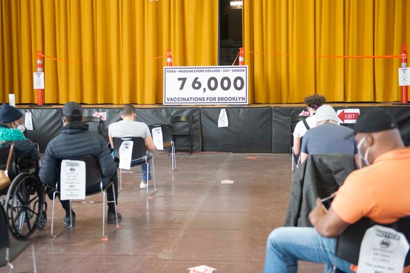 Community members wait in a holding area after receiving their COVID-19 vaccine at a Community Vaccination Center in Brooklyn, N.Y., March 22, 2021. Approximately 140 U.S. Air Force Airmen deployed from 28 installations deployed to the Brooklyn CVC in support of U.S. Army North’s COVID-19 response efforts. Since efforts began, the team aims to vaccinate 3,000 community members each day and have vaccinated more than 76,000 members total. (U.S. Air Force photo by Tech. Sgt. Ashley Nicole Taylor)
