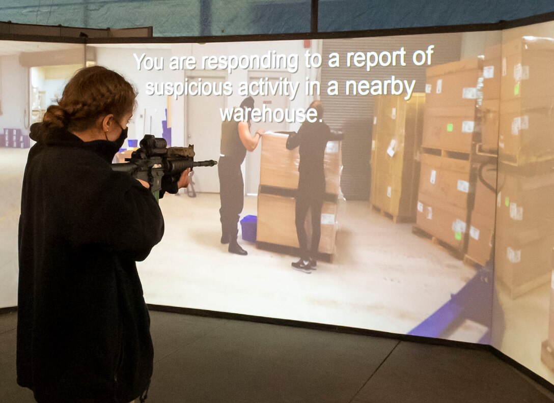 Carly Bassett, Pennsylvania State University Air Force ROTC Cadet, practices the Multiple Interactive Learning Objectives (MILO) firearm training simulator during a tour of the 436th Security Forces Squadron training facility at Dover Air Force Base, Delaware, March 25, 2021. During their stay, Cadets toured various maintenance operation facilities, aircraft and supporting facilities. (U.S. Air Force photo by Airman 1st Class Cydney Lee)
