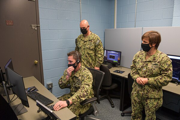 Rear Adm. Brendan McLane, commander, Naval Surface Force Atlantic, tours the new Air Intercept Controller (AIC) training lab with Senior Chief Operations Specialist Adam Siler, Afloat Training Group (ATG) Norfolk�s AIC supervisor and Capt. Mary Hays, ATG Norfolk�s commanding officer. Along with training AICs, the lab will also open training events to shipboard anti-air warfare coordinators (AAWC) to promote AIC/AAWC integration. (U.S. Navy photo by Mass Communication Specialist 2nd Class Jacob Milham/RELEASED)