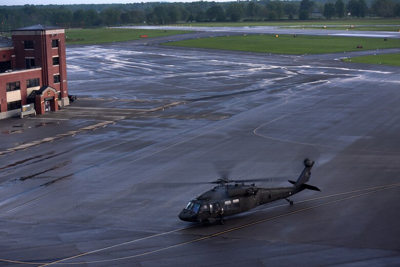 An Army helicopter crew arrives at Fort Knox, Kentucky’s Godman Army Airfield at sunset in May. A Huntsville Center energy savings contract replaced the airfield’s old electrical and lighting system making the airfield the Army’s first to have all LED lighting.