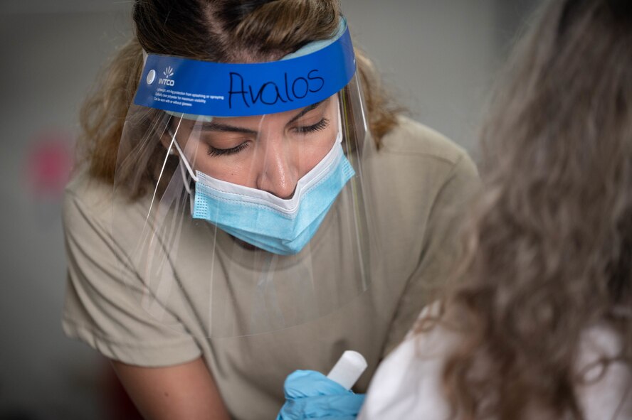U.S. Air Force Airman 1st. Class Linzie Avalos, deployed from Peterson Air Force Base, Colorado, prepares to vaccinate a Tampa community member at the Tampa Community Vaccination Center March 12, 2021 in Tampa, Florida. Avalos is one of nearly 140 Airmen on site at the state-led, federally-supported operation. U.S. Northern Command, through U.S. Army North, remains committed to providing continued, flexible Department of Defense support to the Federal Emergency Management Agency as part of the whole-of-government response to COVID-19. (U.S. Air Force photo by Master Sgt. Holly Roberts-Davis/Luke AFB Public Affairs)