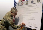 Brig. Gen. Caroline Miller, 502nd Air Base Wing and Joint Base San Antonio commander adds her signature to the 2021 Sexual Assault Awareness and Prevention Month Proclamation at the 502nd ABW headquarters at JBSA-Fort Sam Houston March 29.