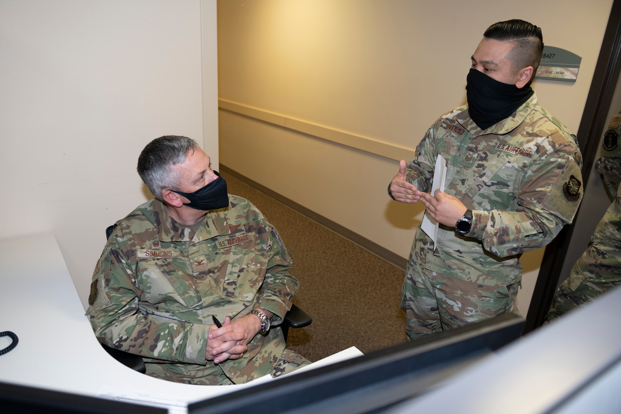 U.S. Air Force Tech Sgt. Michael de Vega, 60th Medical Support Squadron section chief of patient administration, guides Col. Corey Simmons, 60th Air Mobility Wing commander, through a death processing checklist during Leadership Rounds March 26, 2021, at Travis Air Force Base, California. The Leadership Rounds program provides 60th AMW leadership an opportunity to interact with Airmen and receive a detailed view of each mission performed at Travis AFB. (U.S. Air Force photo by Senior Airman Cameron Otte)