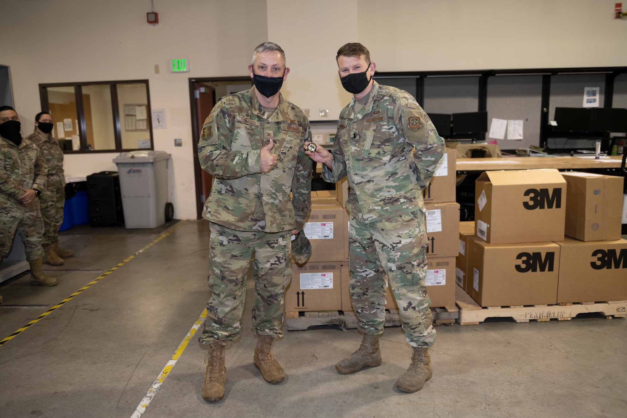 U.S. Air Force Col. Corey Simmons, 60th Air Mobility Wing commander, recognizes 1st Lt. Isaac Bacon, 60th Medical Support Squadron medical logistics intern, as a star performer during Leadership Rounds March 26, 2021, at Travis Air Force Base, California. The Leadership Rounds program provides 60th AMW leadership an opportunity to interact with Airmen and receive a detailed view of each mission performed at Travis AFB. (U.S. Air Force photo by Senior Airman Cameron Otte)