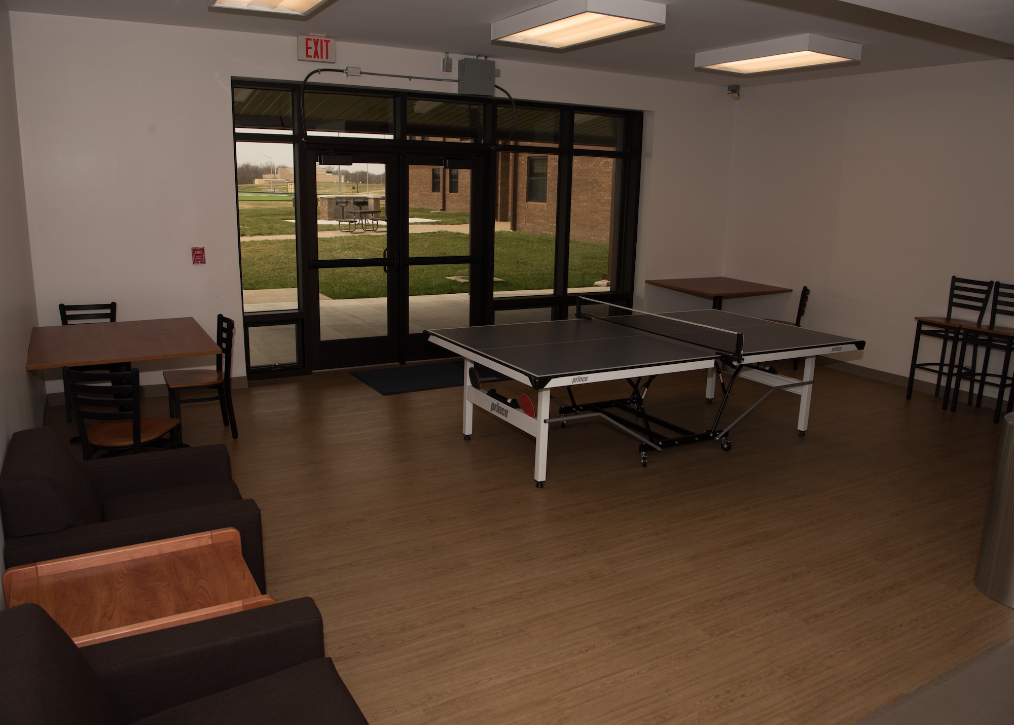 The dayroom in Endeavour Hall contains a ping pong table along with seating and vending machines for Airmen to use.