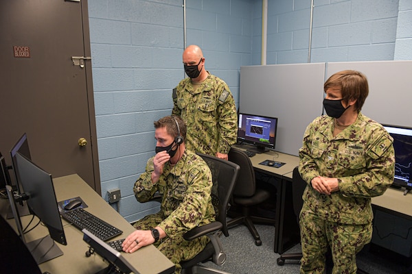 Rear Adm. Brendan McLane, commander, Naval Surface Force Atlantic, tours the new Air Intercept Controller (AIC) training lab with Senior Chief Operations Specialist Adam Siler, Afloat Training Group (ATG) Norfolk�s AIC supervisor and Capt. Mary Hays, ATG Norfolk�s commanding officer. Along with training AICs, the lab will also open training events to shipboard anti-air warfare coordinators (AAWC) to promote AIC/AAWC integration. (U.S. Navy photo by Mass Communication Specialist 2nd Class Jacob Milham/RELEASED)