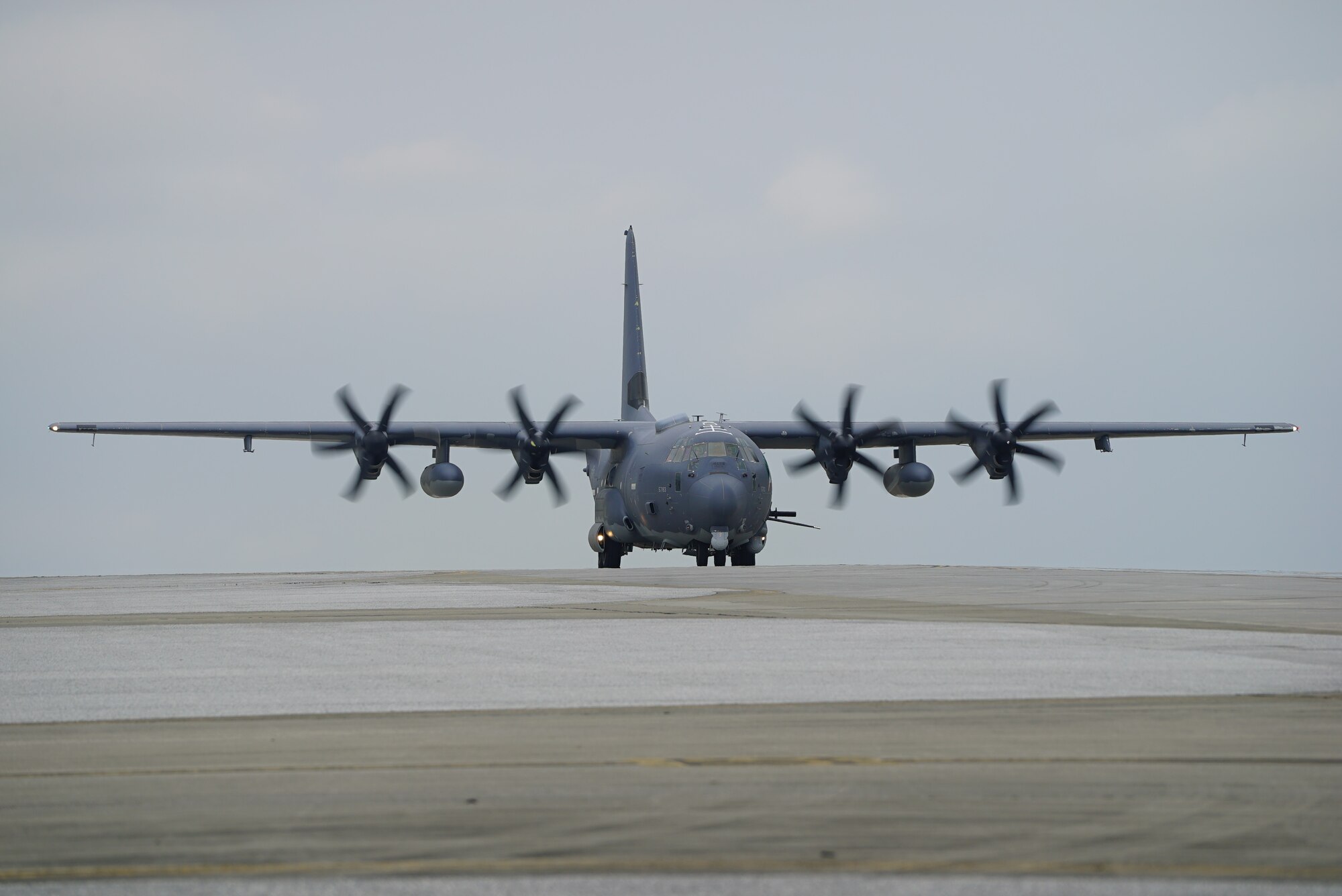 An AC-130J Ghostrider gunship taxis on the flightline at Kadena Air Base.