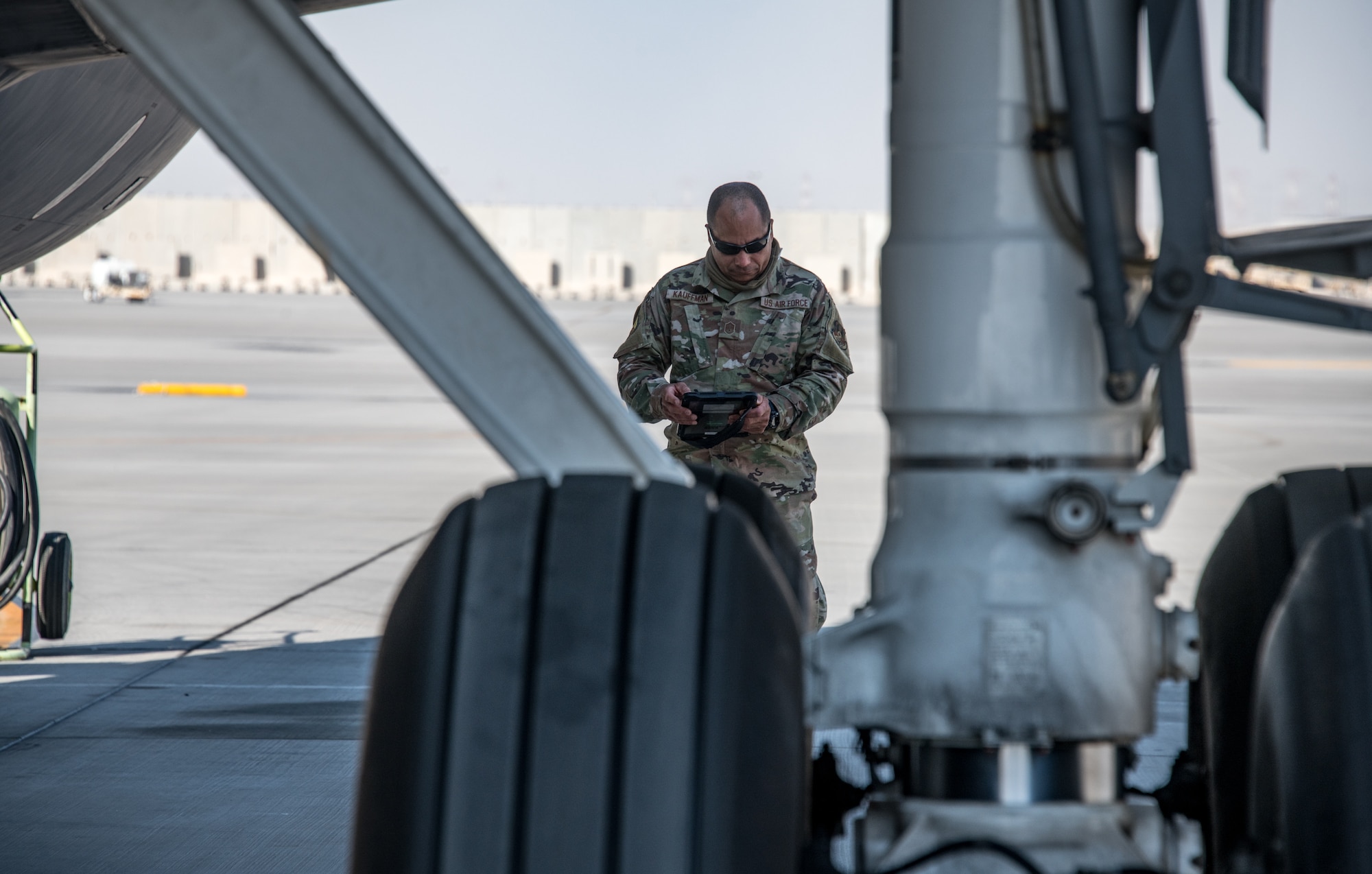 A man reads an ipad screen behind the wheel of an aircraft