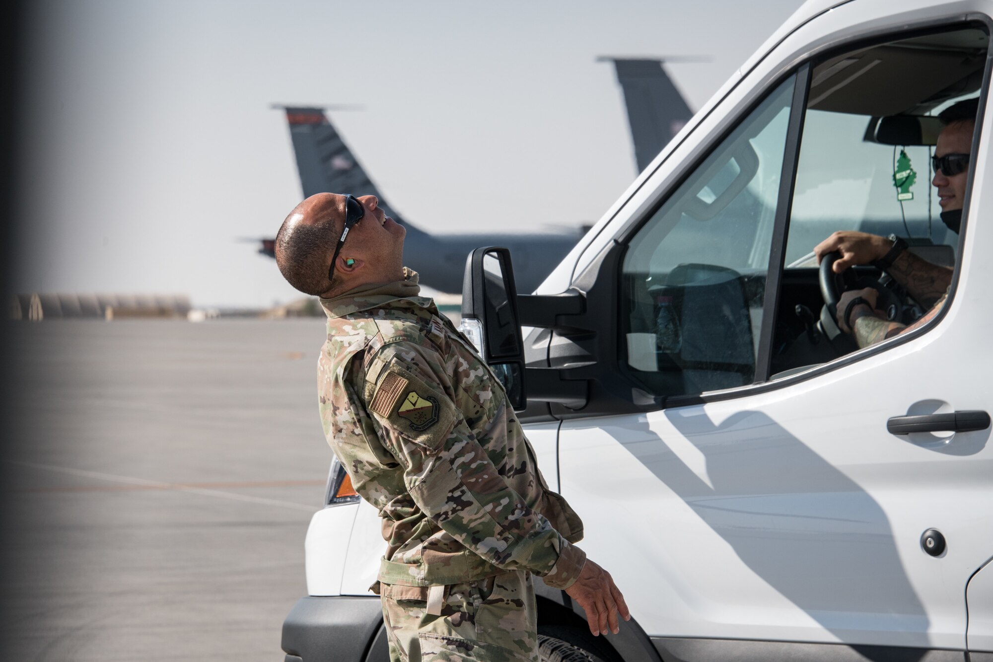 a man in uniform laughs