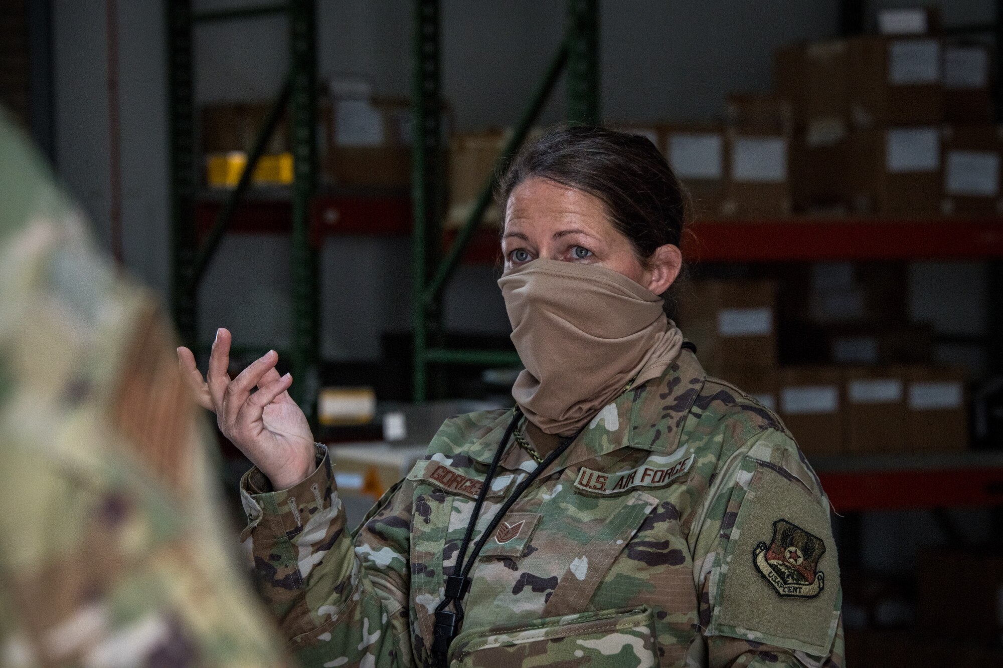 An airman speaks to another airman