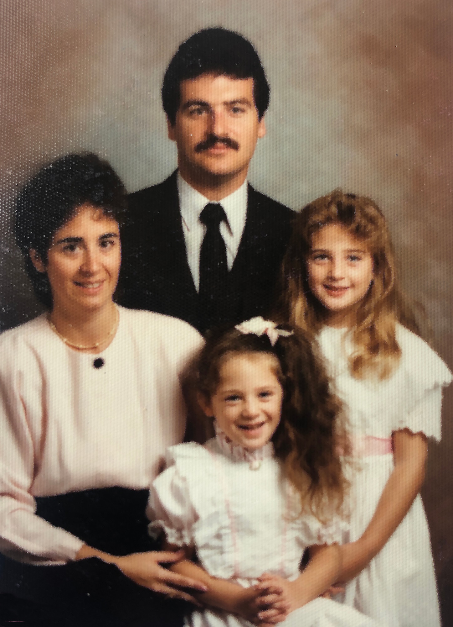 Andrea Hunwick poses for a photo with her parents and sister, around the time of her mother's graduation, 1990. (Courtesy photo)