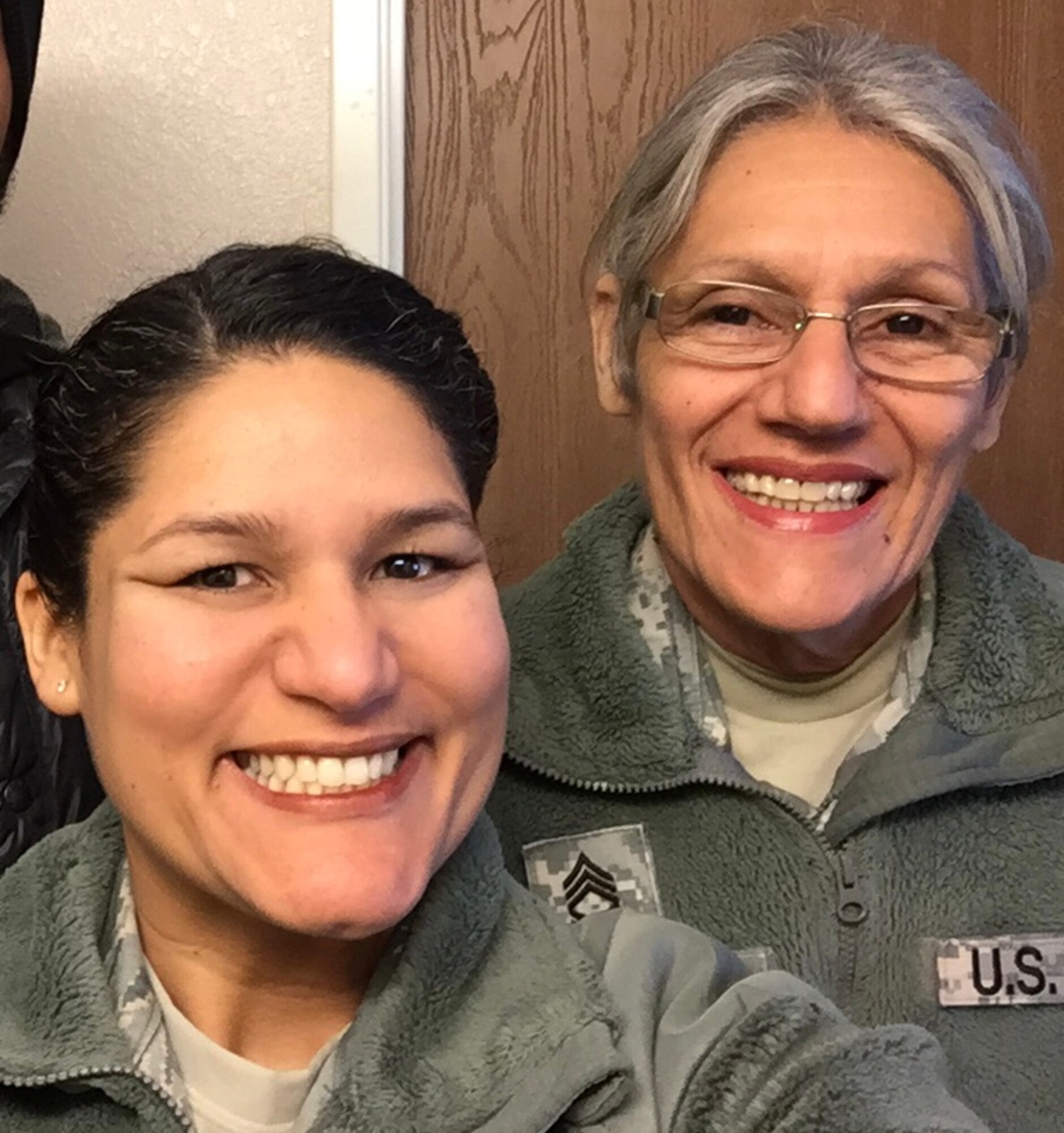 Master Sgt. Namir Laureano, left, smiles for a photo with her mom, Norma Miranda, while attending her brother's graduation from the U.S. Navy's basic training in Chicago, Illinois, March 4, 2016. Miranda retired in 2014 after serving 35 years in the Army National Guard and Army Reserve, and Laureano continues to serve after 16 years in the U.S. Air Force and Air National Guard. (Courtesy photo provided by Master Sgt. Namir Laureano)